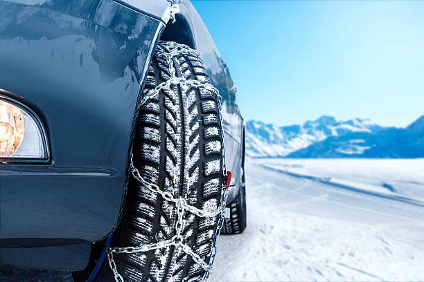 Car with mounted snow chains in wintry environment