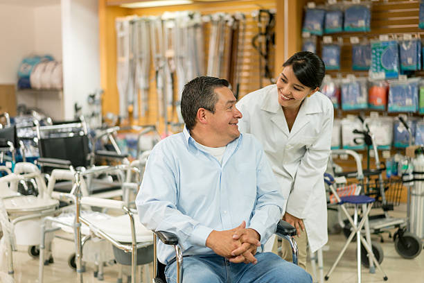 Orthopedist helping disabled man at a health store   medicine concepts